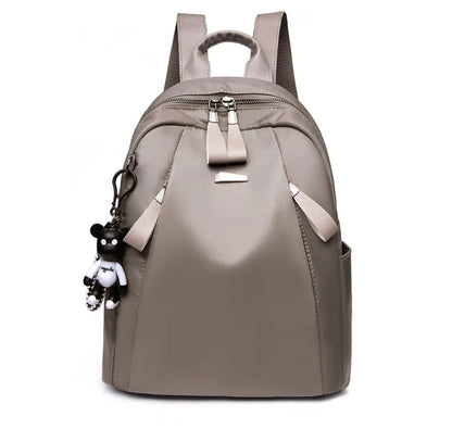 Medium square rucksack in Oxford cloth with two straps and a soft handle, shown in wine red.