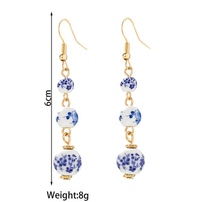 Long retro earrings with blue and white porcelain ceramic beads and geometric alloy construction