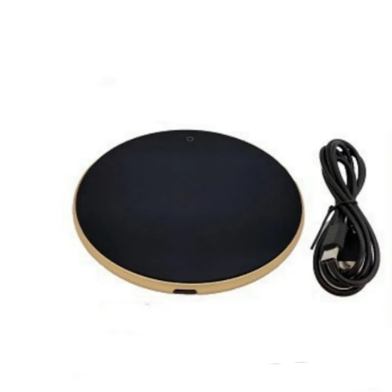 Black USB heating coaster on a desk next to a coffee mug, showing touch controls and coloured indicator light.