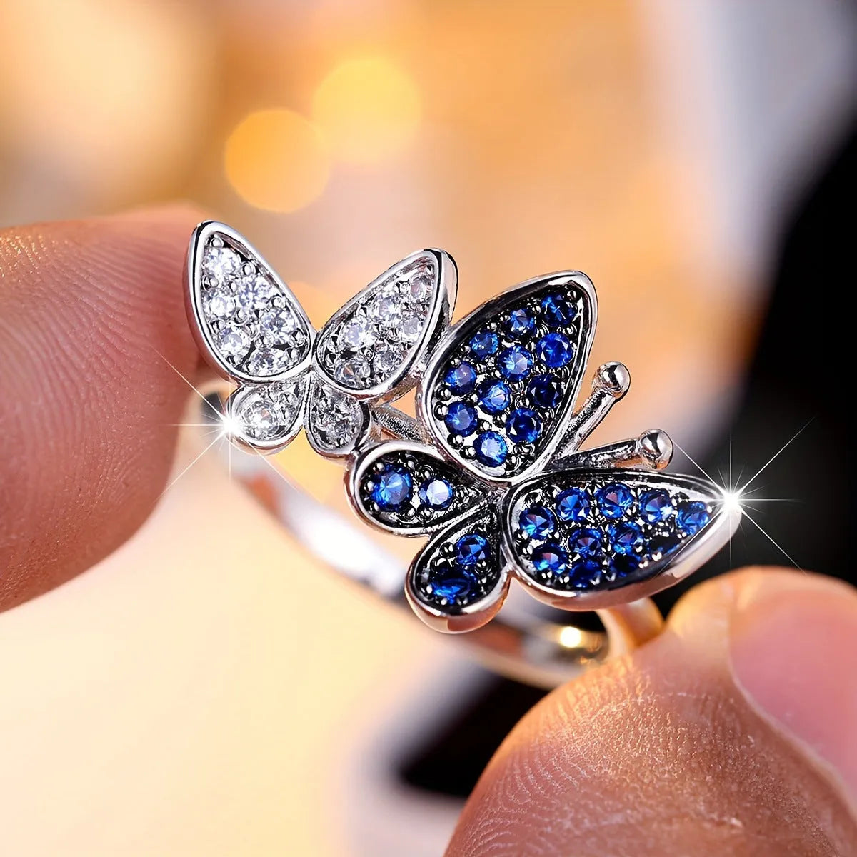 Silver-tone blue and white butterfly design ring for women on a white background.