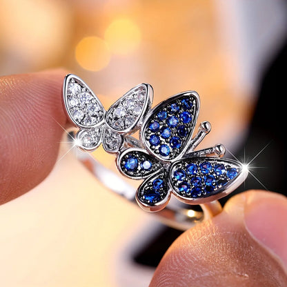 Silver-tone blue and white butterfly design ring for women on a white background.