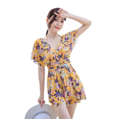 Yellow floral pattern women's one-piece swimsuit on hanger