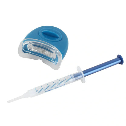 Teeth whitening gel kit with thermoform trays, cold light lamp, 10 gel syringes, and 3D shade guide showing 7-10 improvement