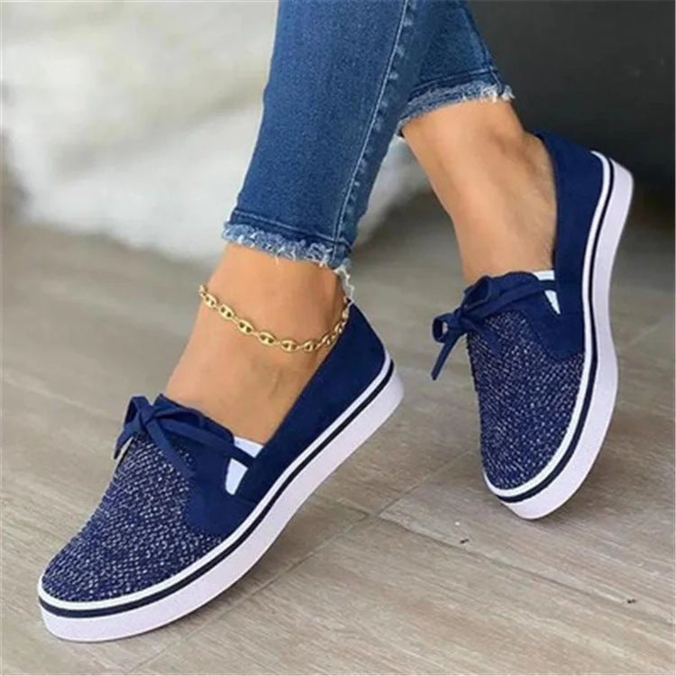 Women's white lace-up canvas flat sneakers with cross straps