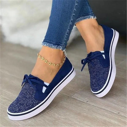 Women's white lace-up canvas flat sneakers with cross straps