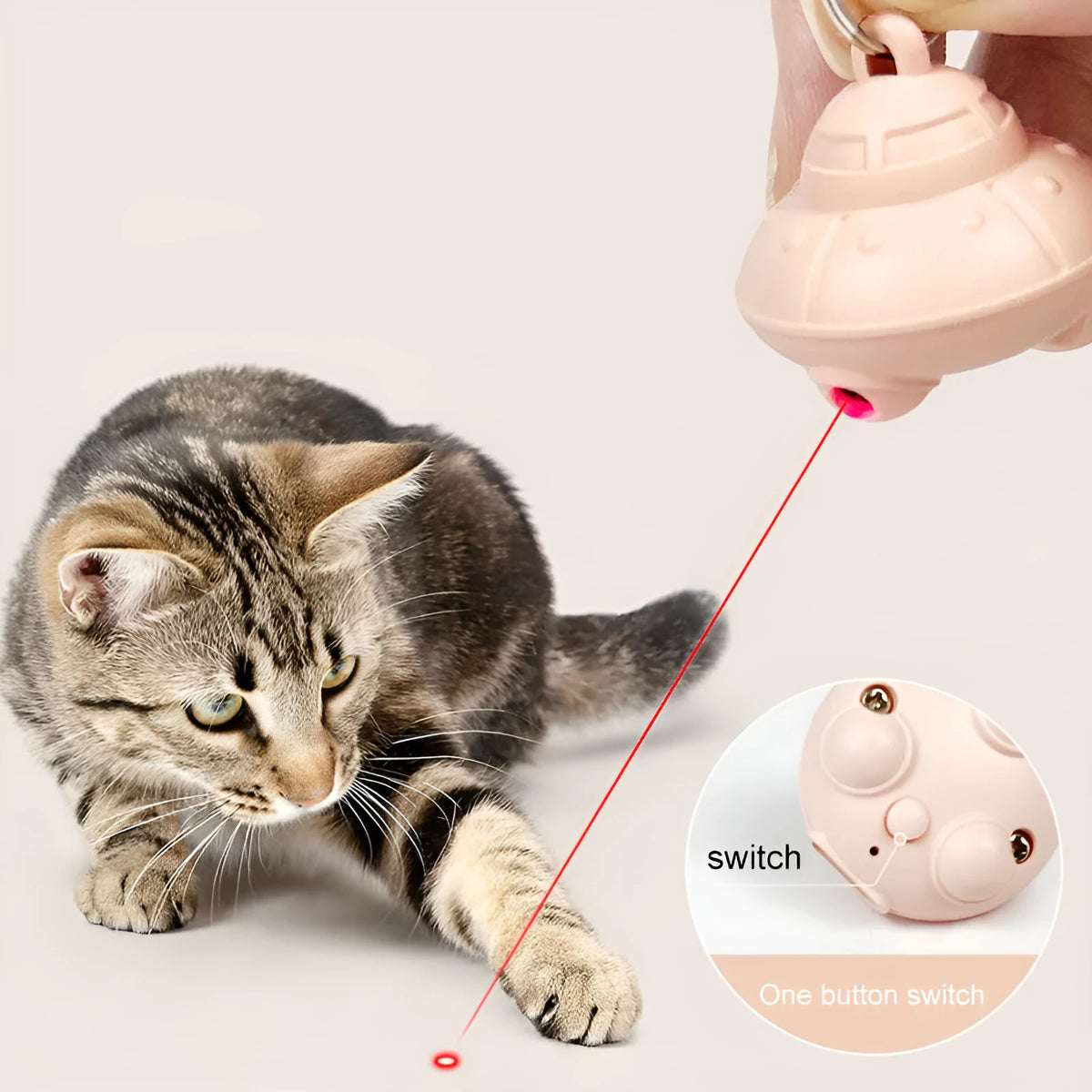 Green automatic cat laser toy unit attached to a black cat collar.