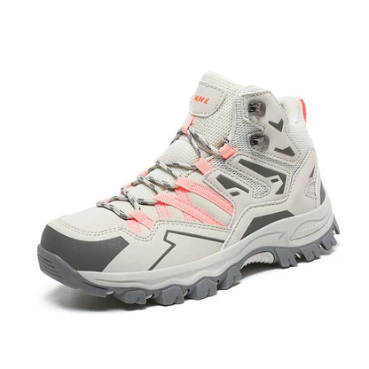 Low-top hiking sneaker in multiple colours on a rocky mountain path, showing lace-up front and rubber sole.