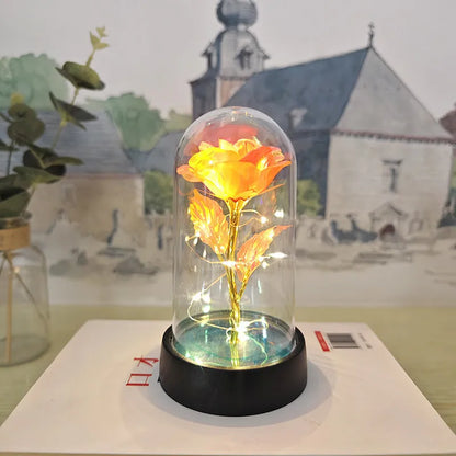 Glass cover small night lamp with plastic flowers, 15cm height, black base, showing colour light options
