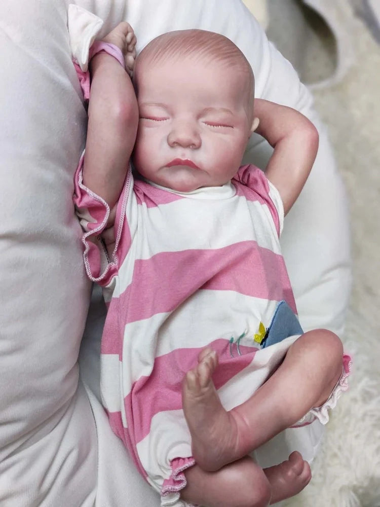 18-inch reborn doll with cloth body and hand-painted vinyl head wearing pink romper