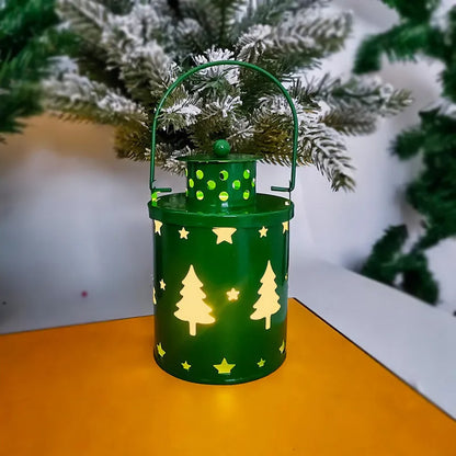 Green wrought iron electronic candle lantern with flickering LED light on a wooden mantel.