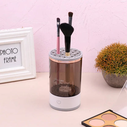 Grey and white portable electric makeup brush cleaner with USB charging cable.