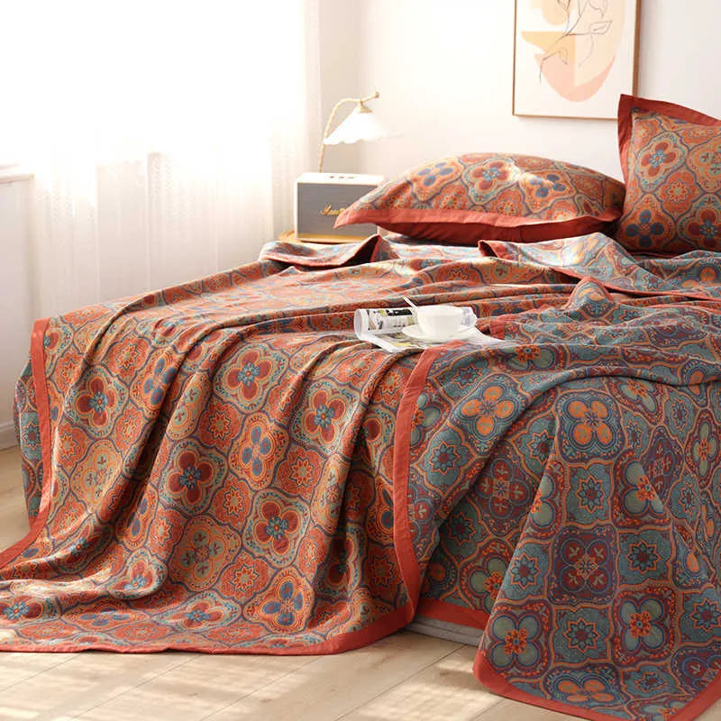 Three-piece cotton gauze bed set with floral print, showing blanket and pillowcases on a bed.