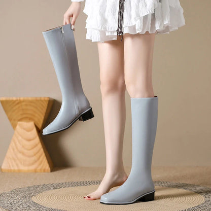 Black square toe over-the-knee boots with 4cm chunky heel showing leather interior and rubber sole