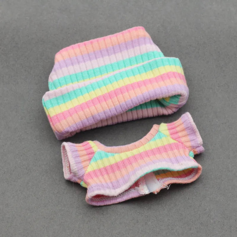 Doll clothes set with knitted flanging hat and T-shirt in multiple colours including pink, white, and stripes.