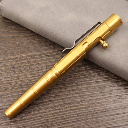 Brass tactical pen with press bolt mechanism showing cylindrical design and six ring details