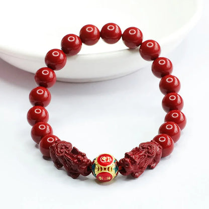 Purple gold sand cinnabar bracelet with carved double Pixiu design, 8mm beads.