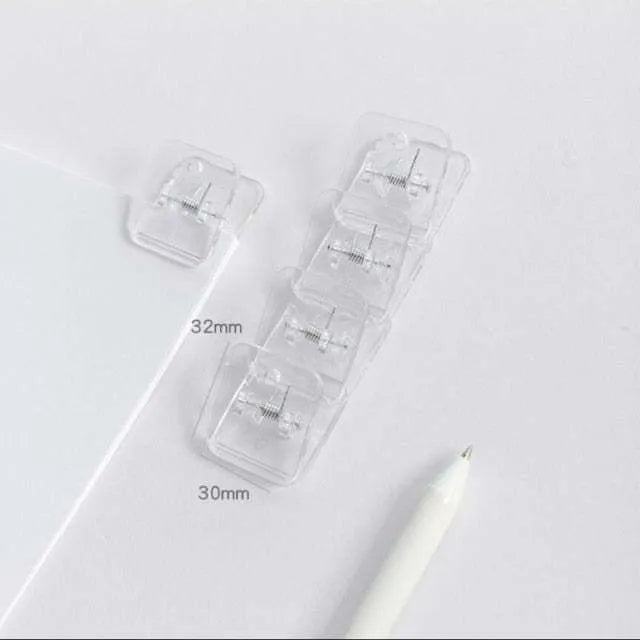 Square plastic photo holder in black, white, and transparent colour options on desk