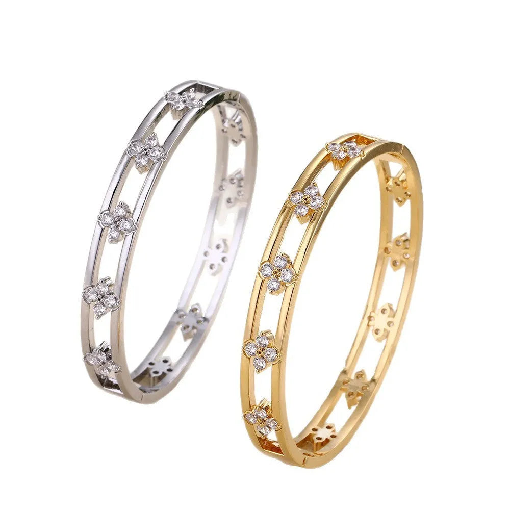 Hollow women's bracelet with four-leaf clover design and inlaid zircon stones in gold or silver finish.