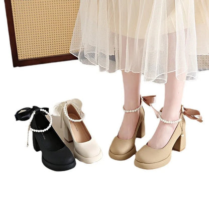 Women's beige Mary Jane shoes with chunky heel, ankle strap, pearl buckle, and round toe on a rubber sole.