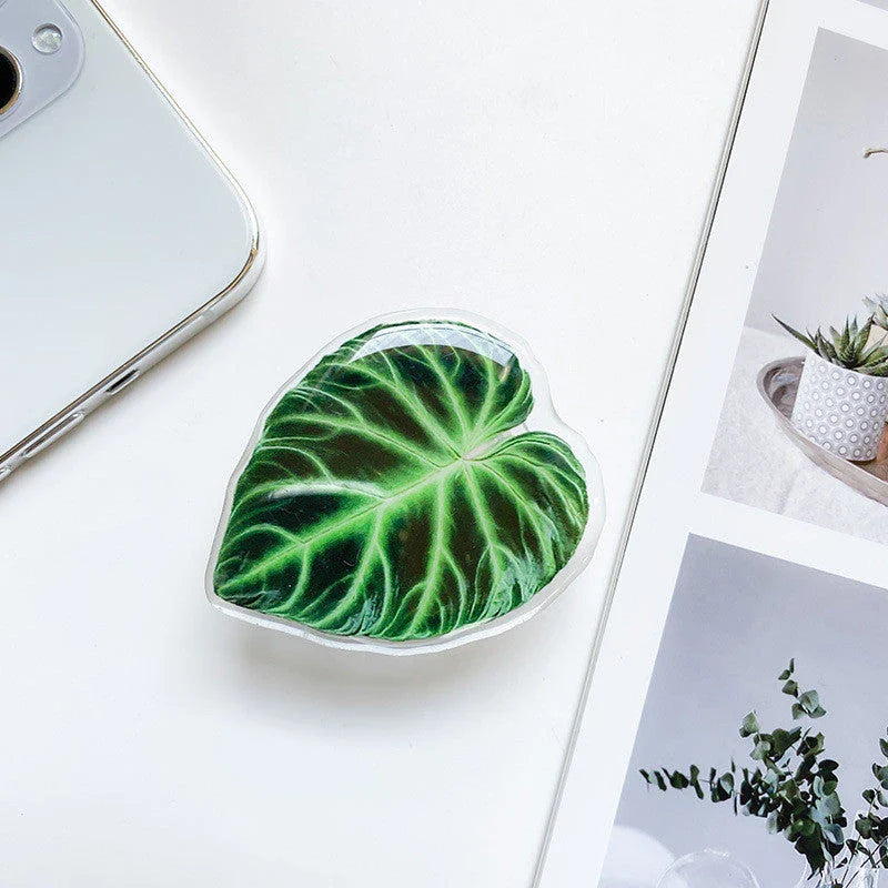 Stylish leaf-inspired smartphone stand with secure grip and adjustable viewing angle for hands-free use