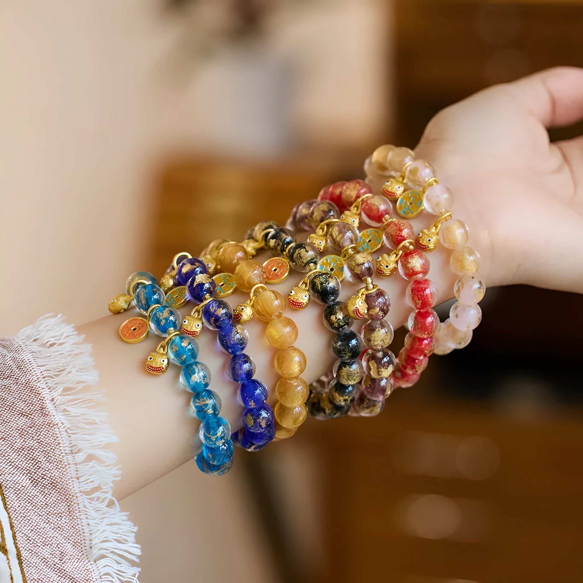 Handmade national style bracelet with coloured glaze swallowing gold beast charm on beaded band.