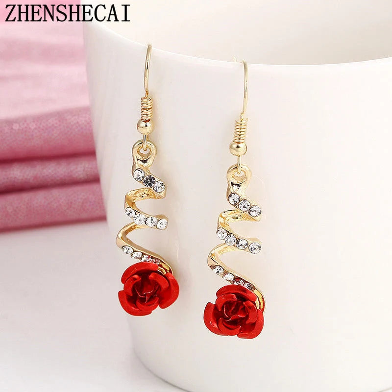 Ethnic red rose drop earrings with big rhinestones in rose gold spiral design