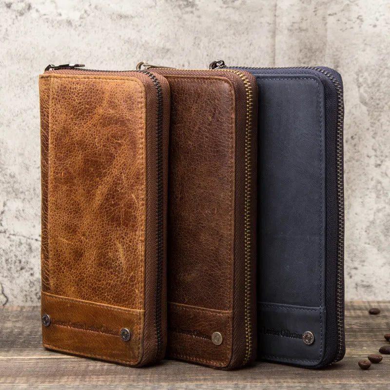Men's brown genuine cowhide leather long wallet open to show card slots, RFID protection symbol, and zippered coin section.