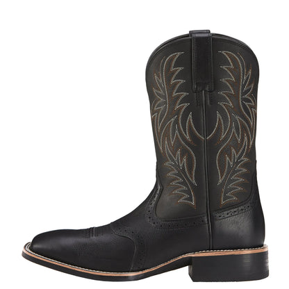 Black Western cowboy boot with vintage embroidery, square toe, and low heel on a rubber sole