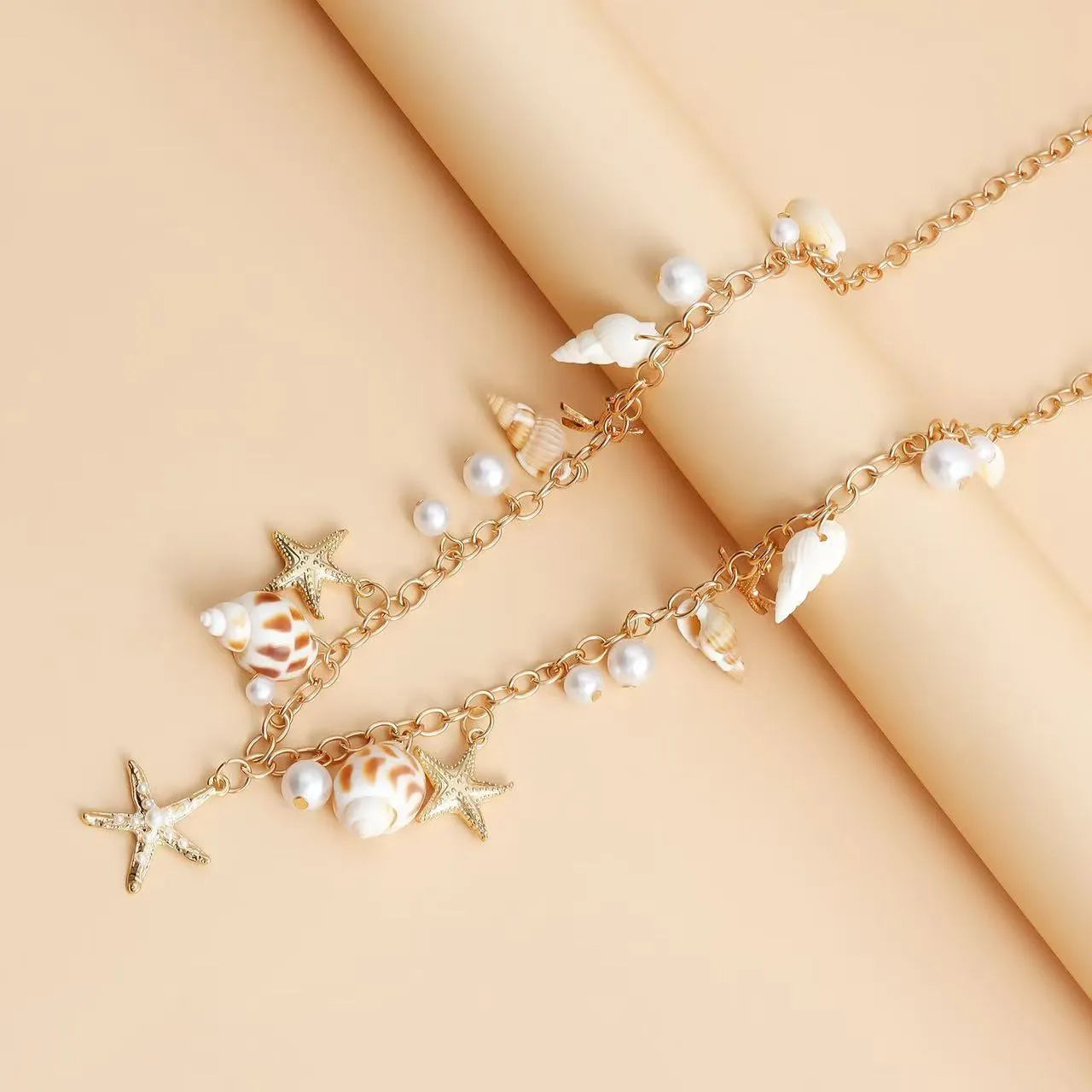 Women's alloy waist chain and bracelet set with star charms on a white background.