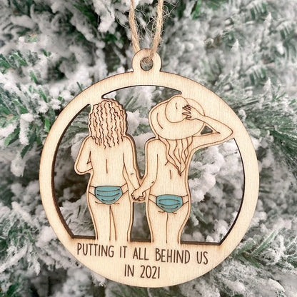 Wooden hollowed-out Christmas ornament with intricate snowman and deer laser-cut design