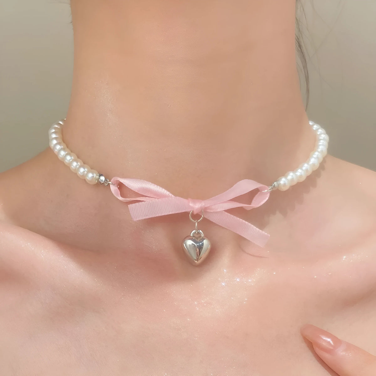 Love heart and bow tie clavicle chain necklace with pearl inlay, shown in White K Love 028 and White K Bow 026 options.