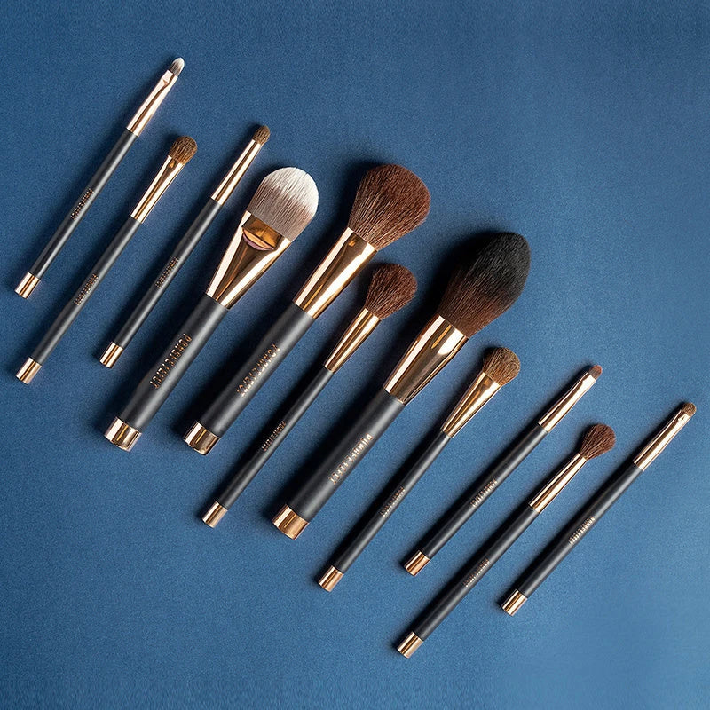A premium makeup brush set with a sleek black and gold design, featuring 11 essential brushes and a magnetic holder for easy organization.