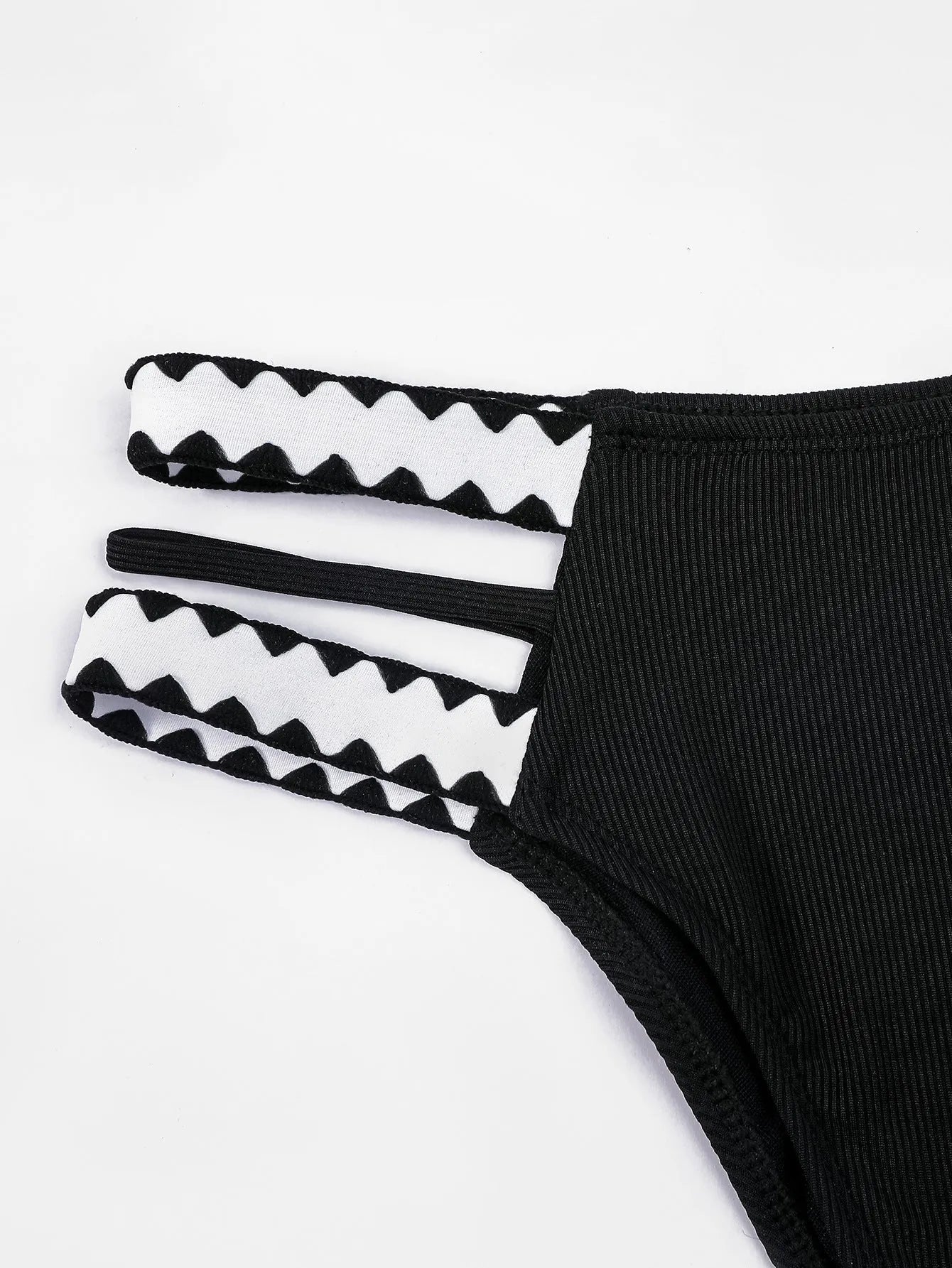 Black hollowed-out split briefs swimsuit for women made from polyester fabric