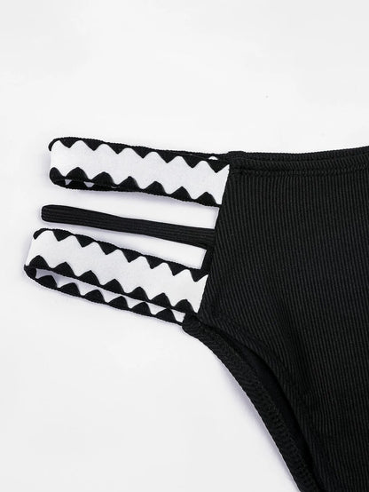 Black hollowed-out split briefs swimsuit for women made from polyester fabric