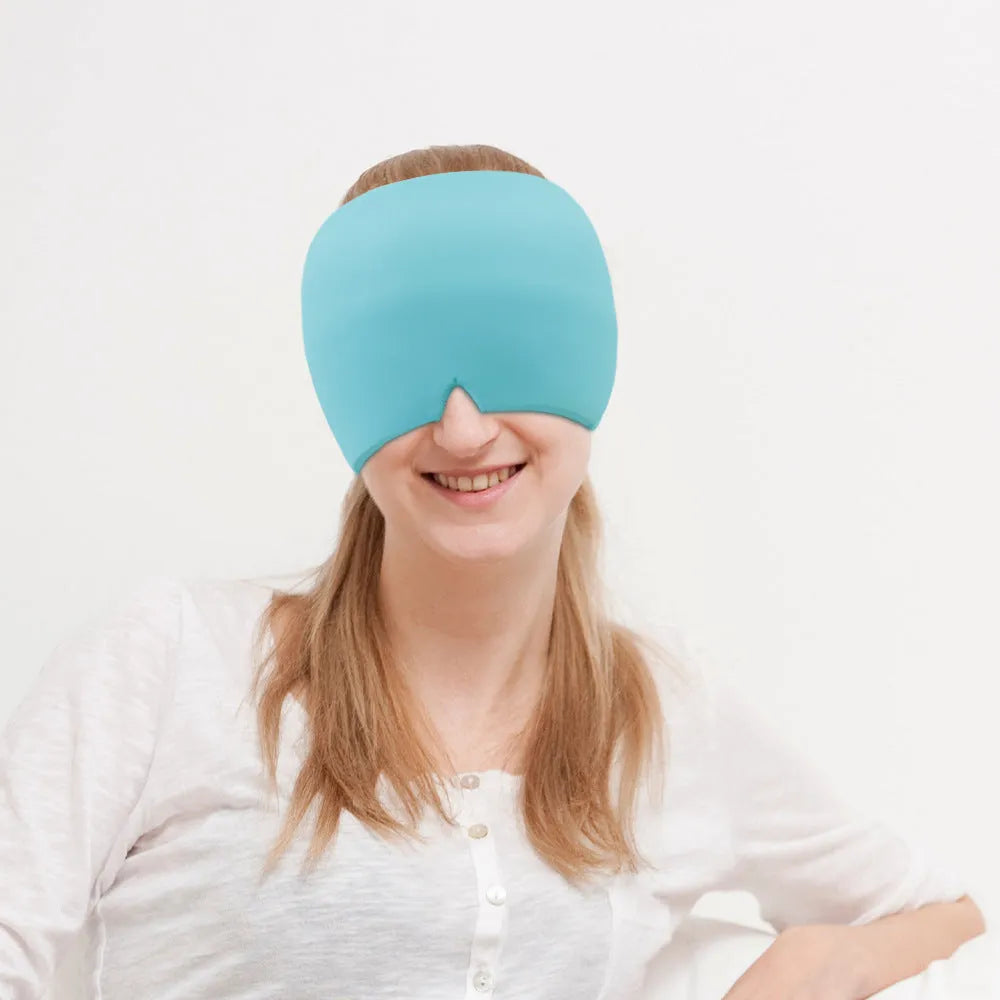 Black elastic cooling gel eye mask for headache relief placed on a forehead.