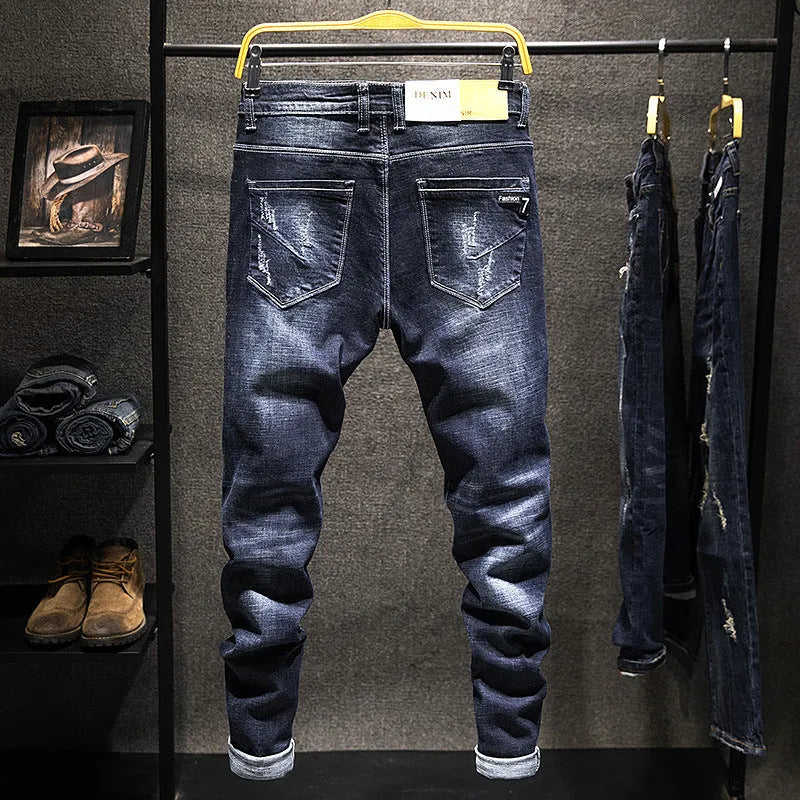 Men's slim-fitting dark blue denim jeans with micro-elasticity, mid-waist design, and standard trousers length on hanger