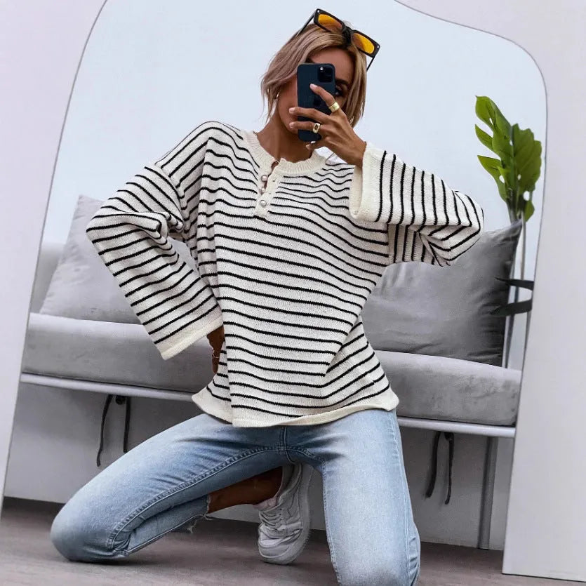 Women's black and white striped loose top with drop shoulders and button detail