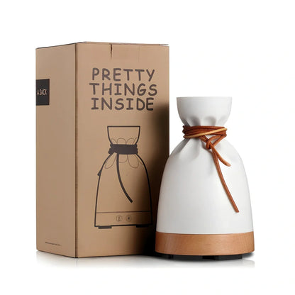 Warm yellow aromatherapy humidifier with beech wood elements and 140ml water tank capacity