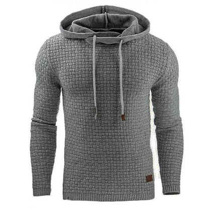 Man wearing a cotton-polyester blend hooded sweatshirt in grey, showing the front design and hood.