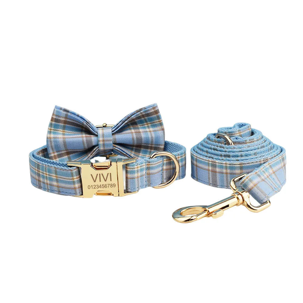 Sky blue grid pattern fabric dog collar, leash, vest, and bow set on a white background.