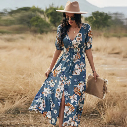 Yellow floral print women's dress with V-neck, short sleeves, elastic waist, and a large hemline midi skirt.