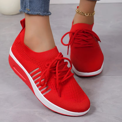 Women's red platform sneakers with mesh upper and front lace-up design on rubber sole