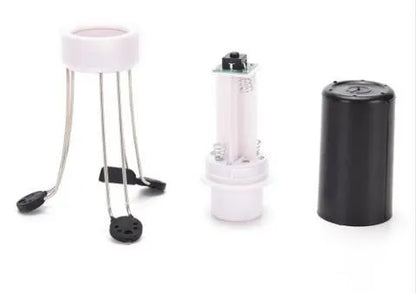 White and black wireless automatic kitchen stirrer with three-speed button, shown next to a saucepan.