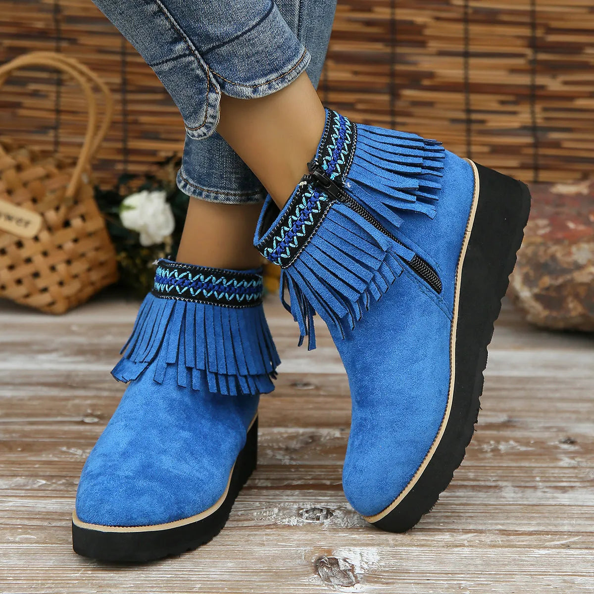 Women's thick bottom wedge bootie in suede with side zipper and tassel detail, available in multiple colours.