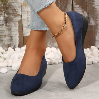 Women's black pointed toe wedge pumps with suede upper and low rubber sole