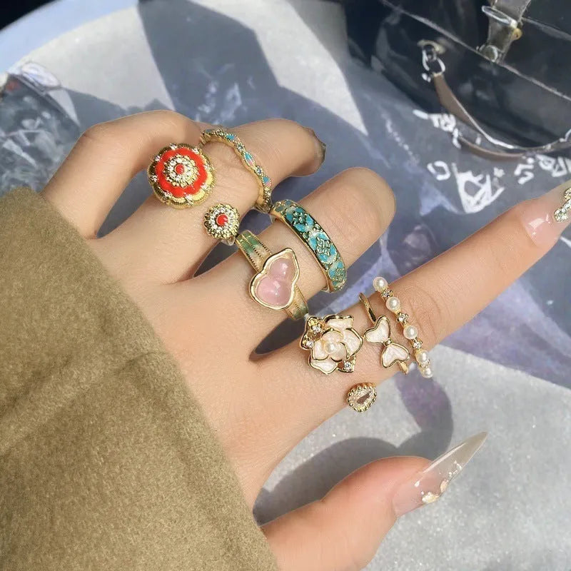 Adjustable copper gourd ring with zircon stones showing flower and bow design elements