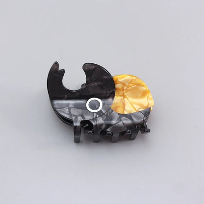 Handmade cartoon insect beetle grip hair clip or brooch in green, orange, or white designs.