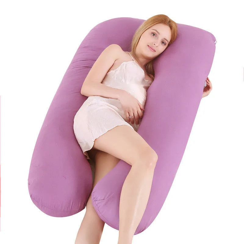 Large U-shaped pregnancy support pillow with removable cover and abdominal support belt.