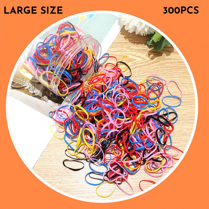 Multicoloured assortment of thin TPU elastic hair bands for babies and children in a reusable plastic container.