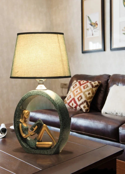 Blue reading night light with resin base and cloth shade measuring 20x39.8cm